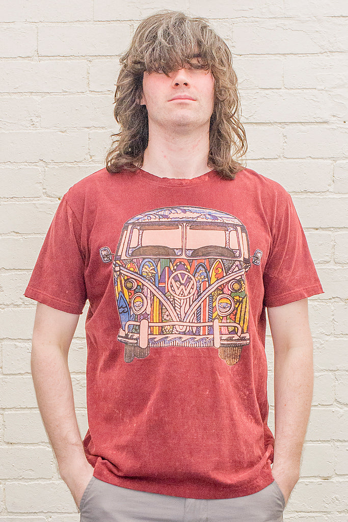 model wearing a deep red or maroon stonewash t-shirt printed with a colourful 1970s style doodle artwork of a split screen volkswagen kombi van with surf themed paintwork from the front