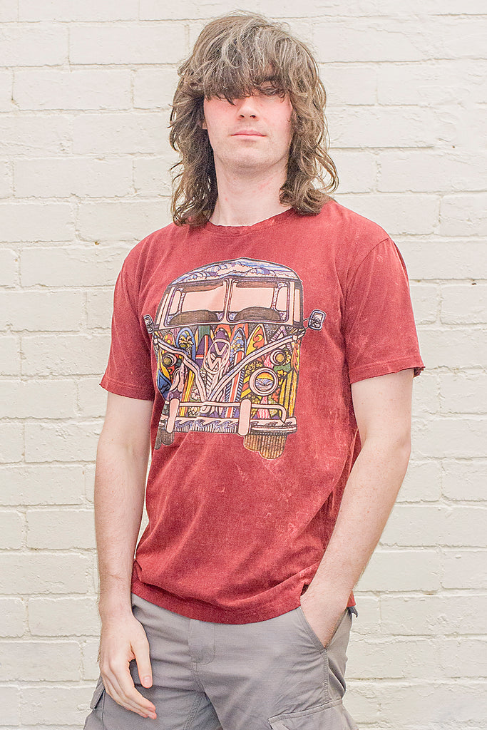 model wearing a deep red or maroon stonewash t-shirt printed with a colourful 1970s style doodle artwork of a split screen volkswagen kombi van with surf themed paintwork from the front