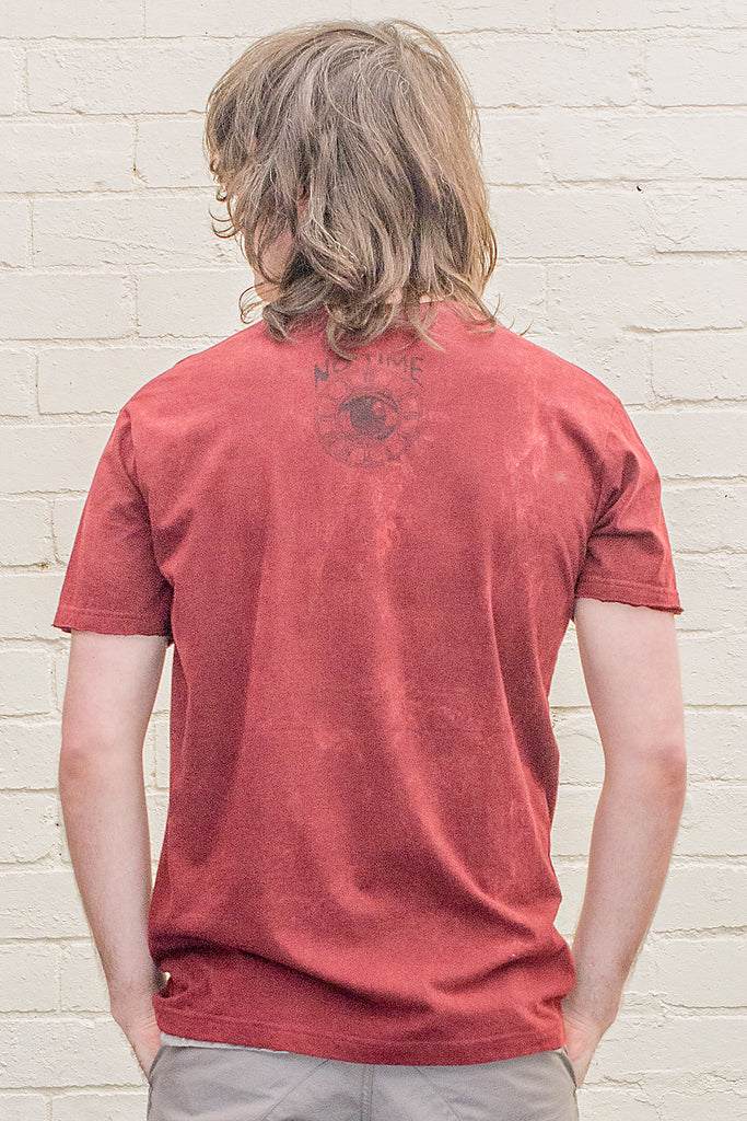 model wearing deep red or maroon stonewash t-shirt with the no time brand logo printed on the back