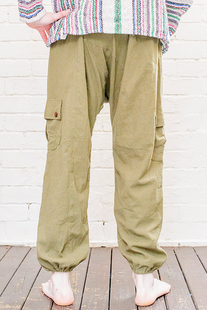 model wearing full length odyssey pants in green from back