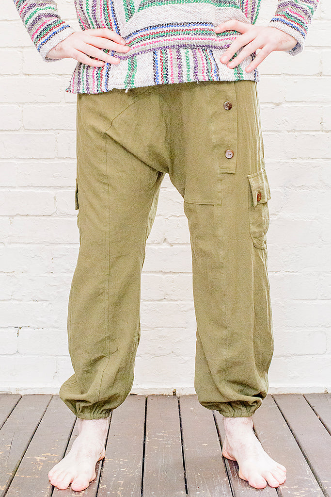 model wearing full length odyssey pants in green from front