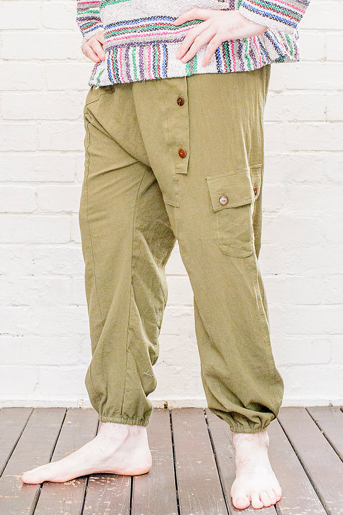 model wearing full length odyssey pants in green from front