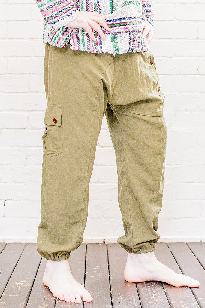 model wearing full length odyssey pants in green from front