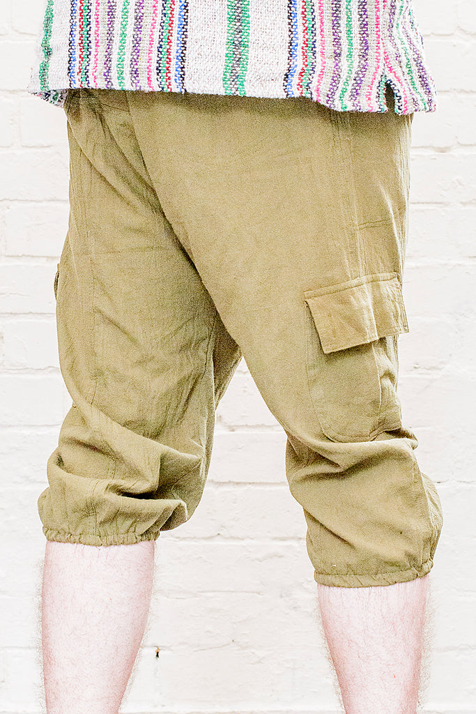 model wearing three quarter length odyssey pants in green from back