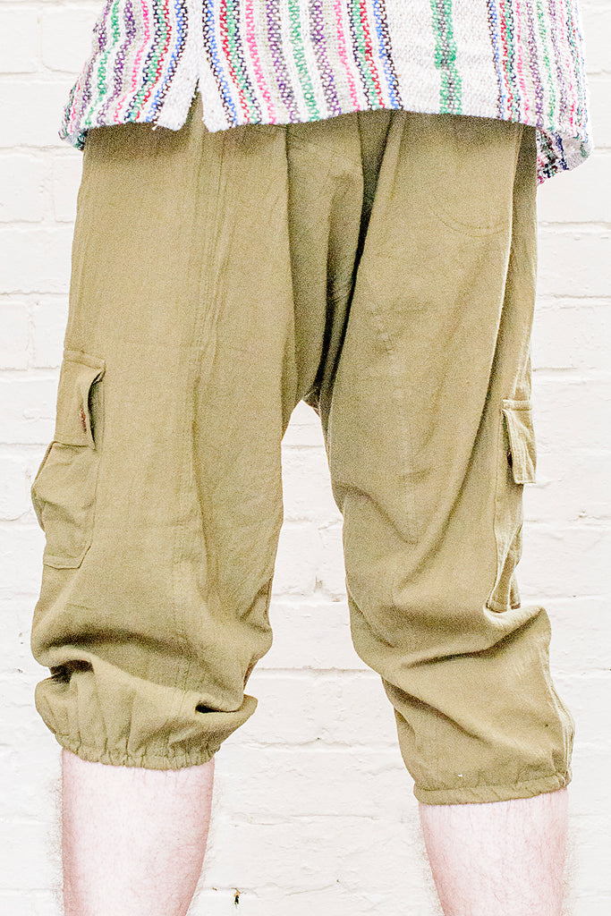 model wearing three quarter length odyssey pants in green from back