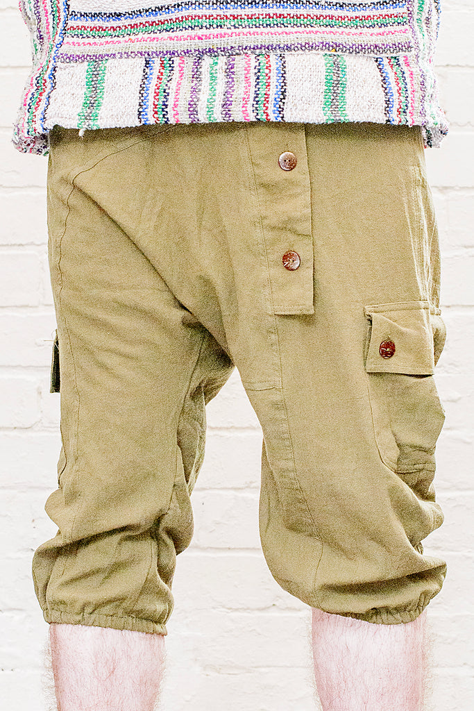 model wearing three quarter length odyssey pants in green from front