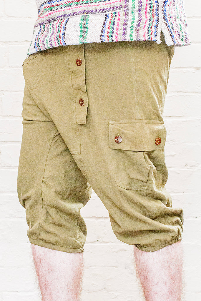 model wearing three quarter length odyssey pants in green from front