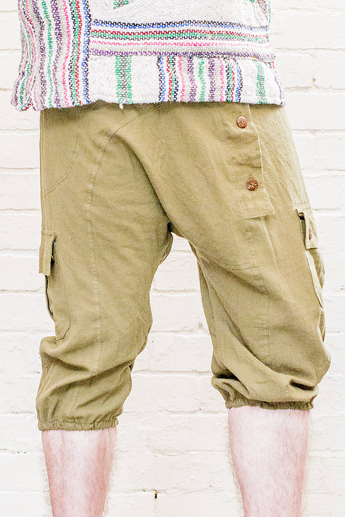 model wearing three quarter length odyssey pants in green from front