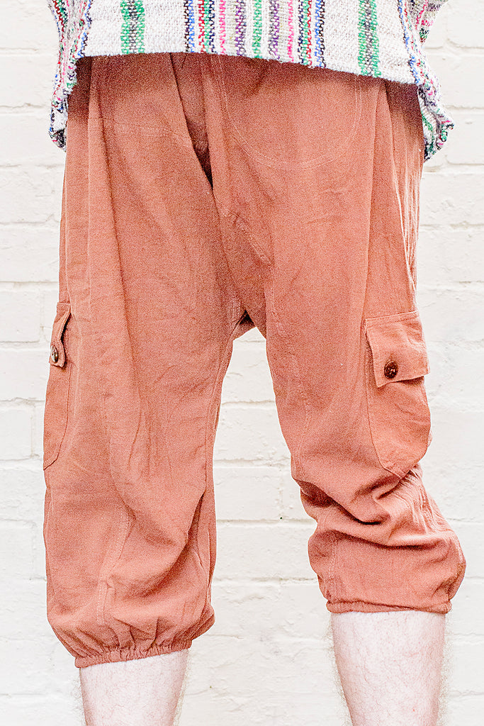 model wearing three quarter length odyssey pants in rust from back