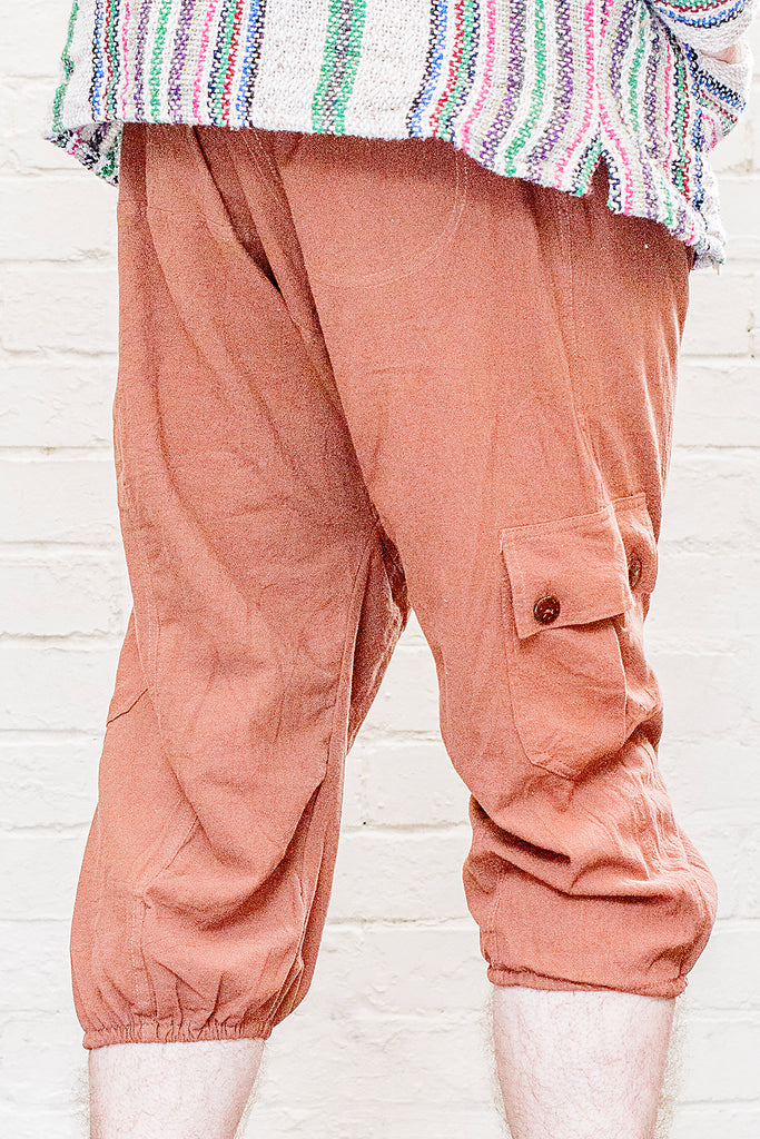 model wearing three quarter length odyssey pants in rust from back