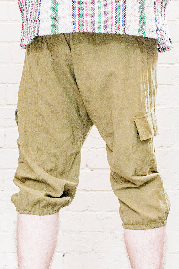 model wearing three quarter length odyssey pants in green from back