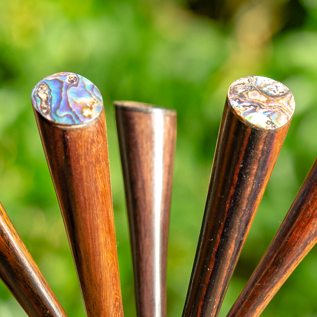 thin cone shaped wooden hair stick with paua mother of pearl inlay on angled end detail