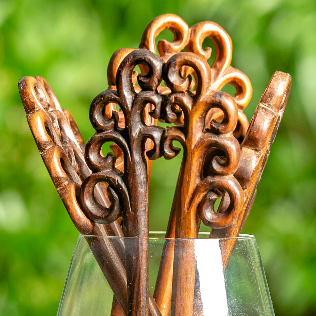 hand made wooden double prong hair stick with naive stylised plant fronds carved at end detail