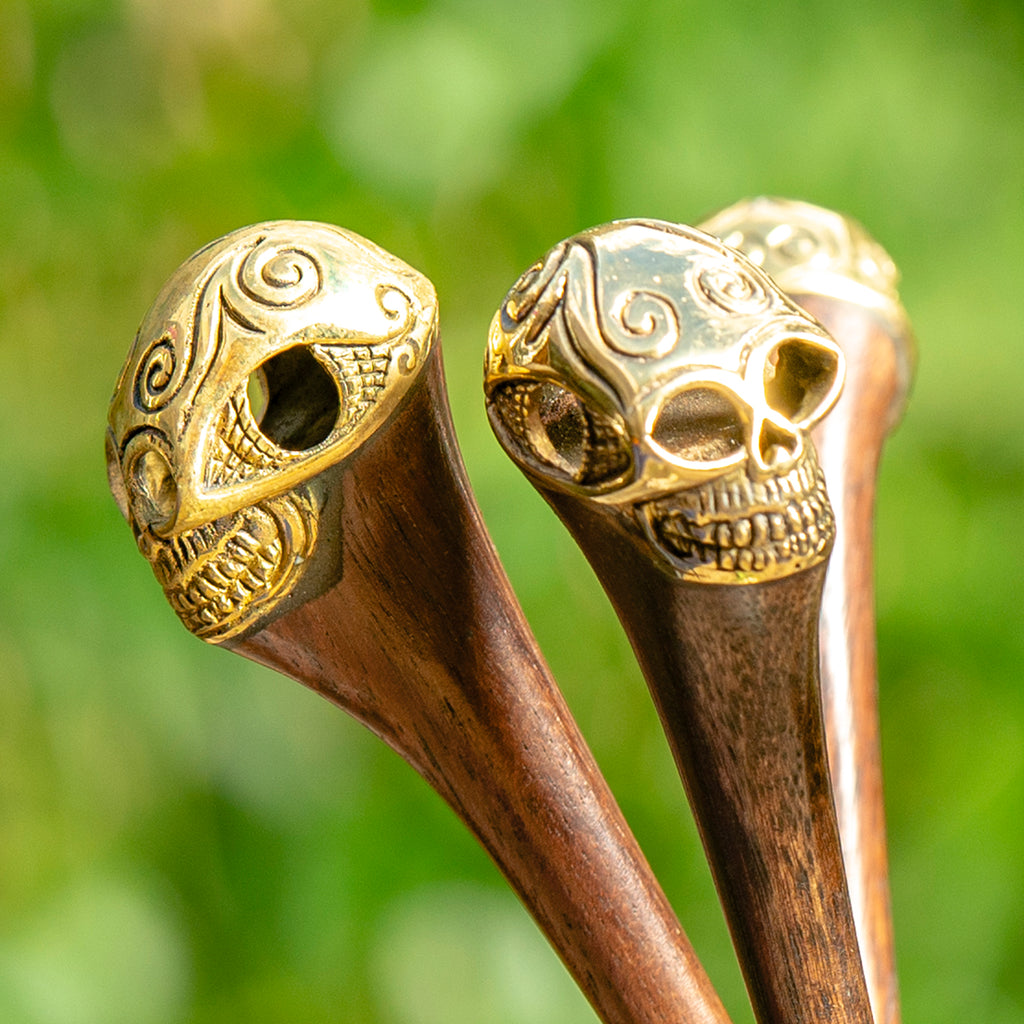 wooden hair stick with ornate carved brass skull at end detail