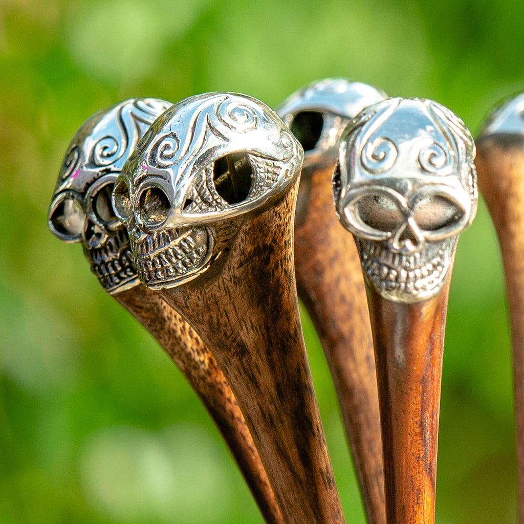 wooden hair stick with intricate carved silver metal skull at end detail