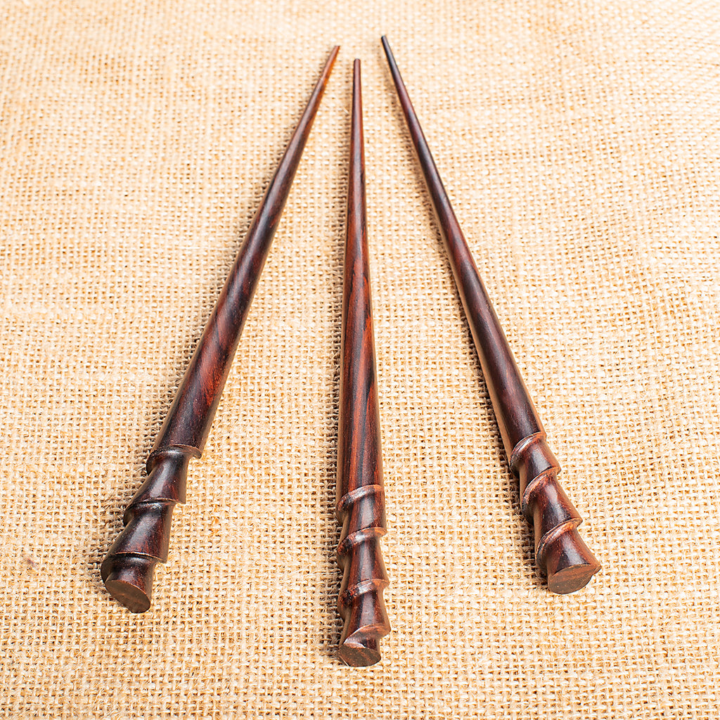 long slender cone shaped hair stick with spiral carved at end