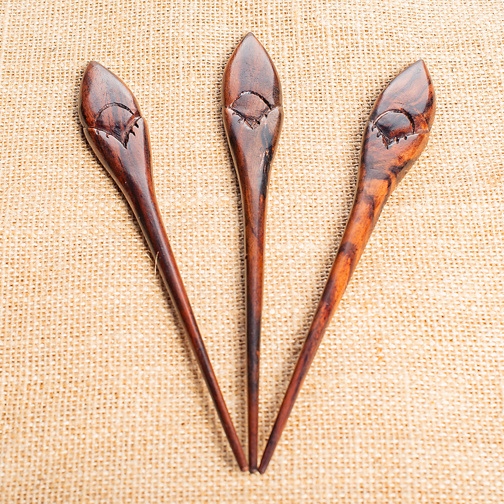wooden hair stick with naive tribal flower motif carved at end