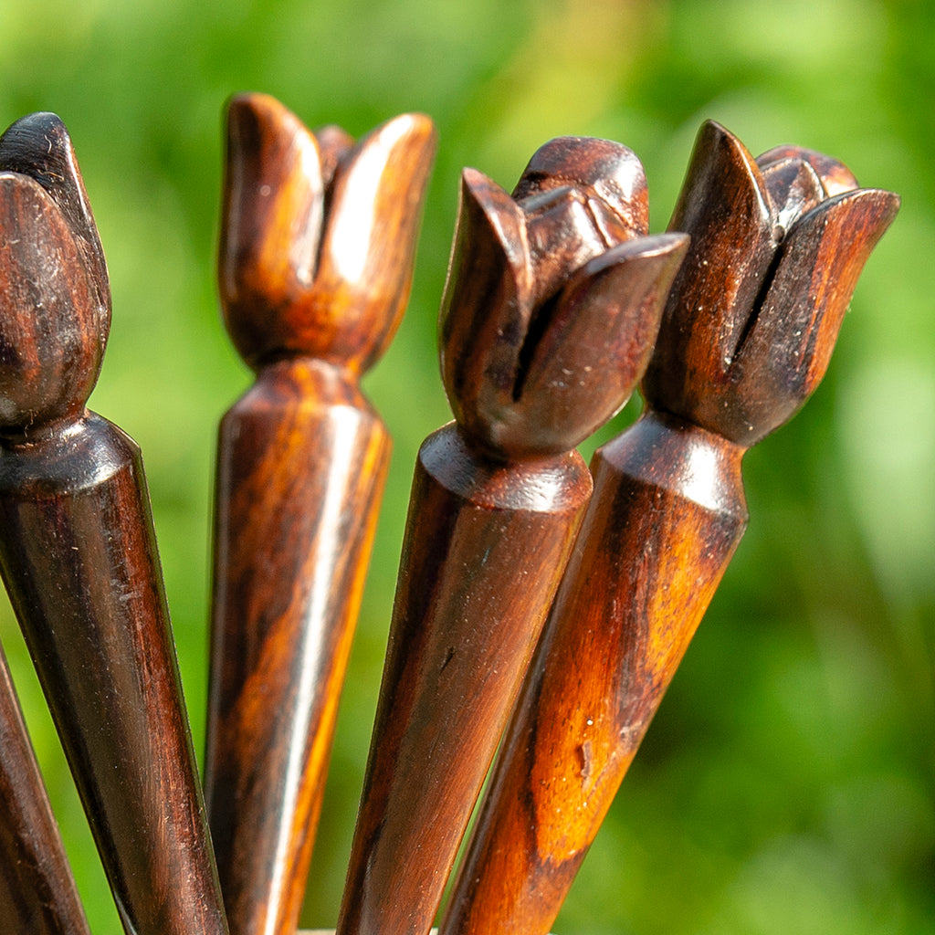 thin cone shaped wooden hair stick with naive tulip shaped flower carved at end detail