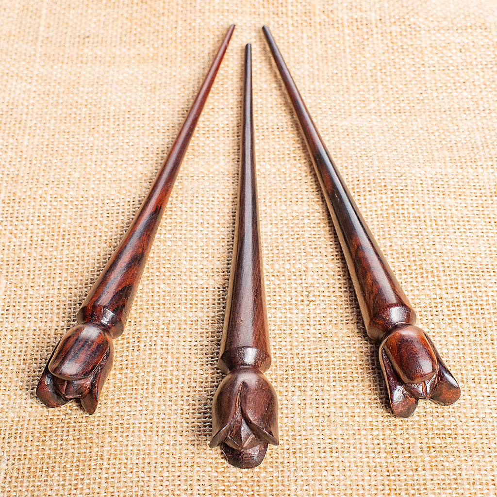 thin cone shaped wooden hair stick with naive tulip shaped flower carved at end