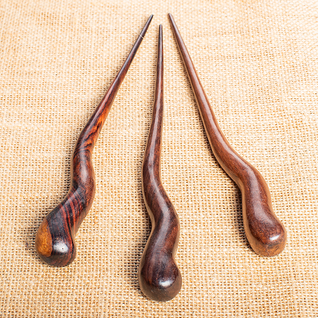 tapered wooden hair stick hand carved in a wavy design