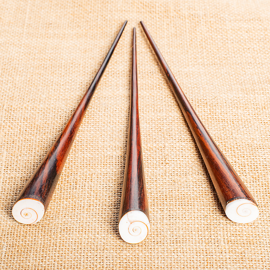 thin cone shaped wooden hair stick with shell spiral inlay at angled end