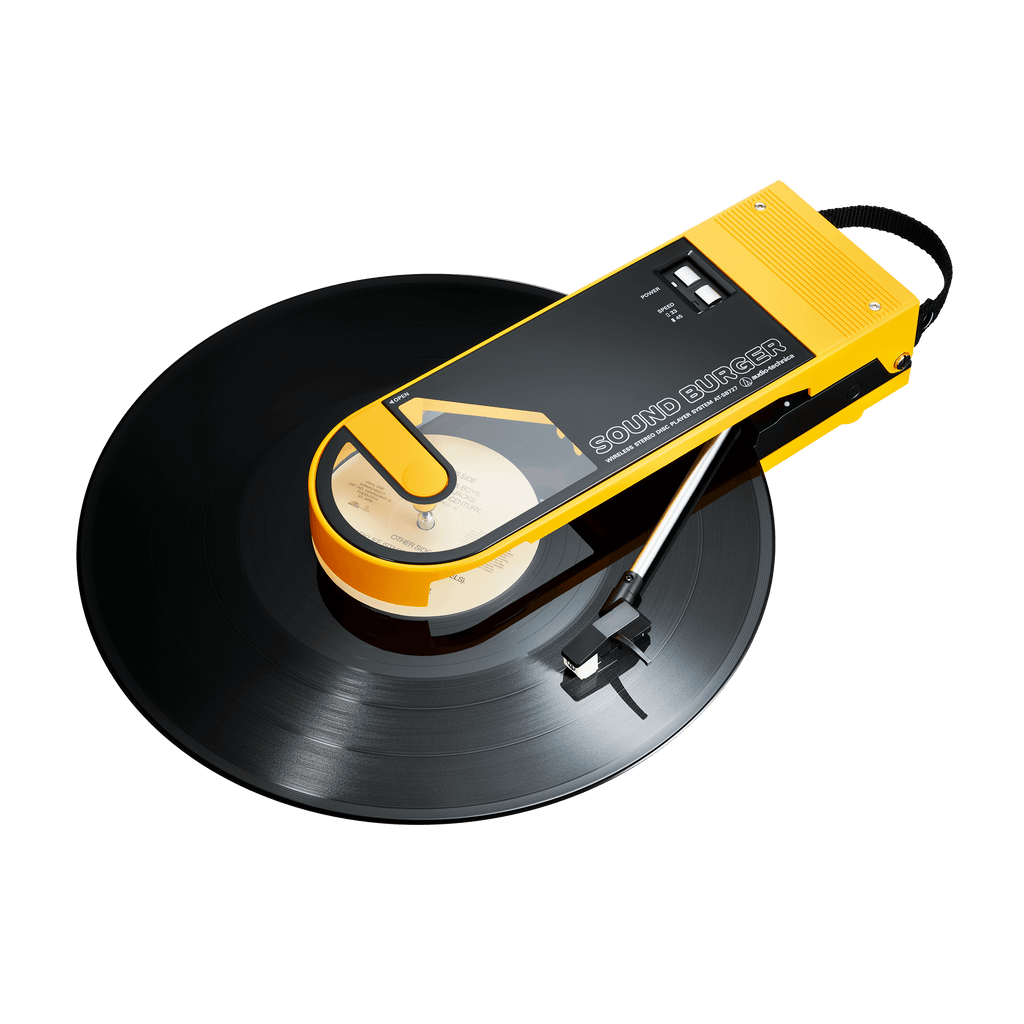 Audio Technica sound burger at-sb727 portable usb and bluetooth turntable in yellow from above front three quarter with record playing