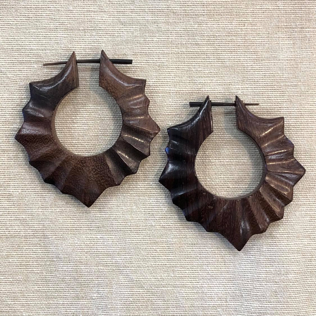 Two rosewood earrings featuring a floral design