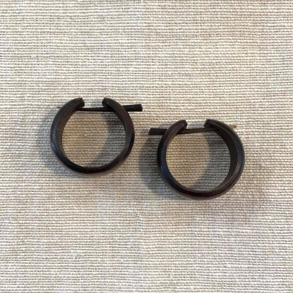 Two hooped earrings crafted from rosewood