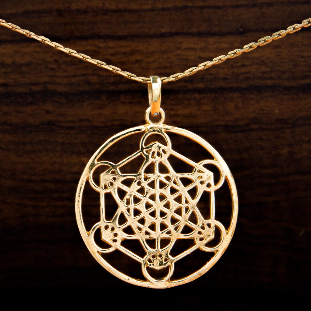 A brass pendant featuring a metatron symbol inside a circle