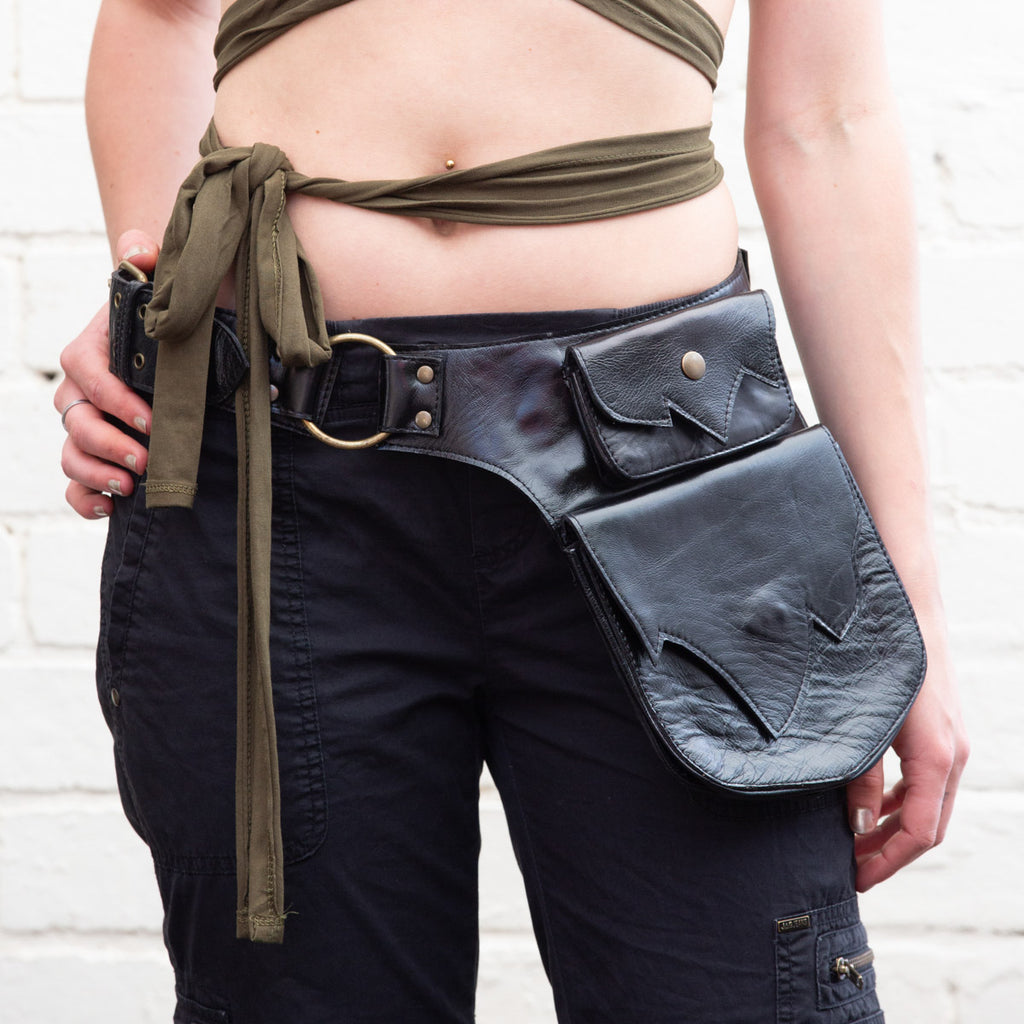 Black Leather Hip Belt Bag with one large and one small pocket brass buckle ring and studs with angular wing-like detailed edges front