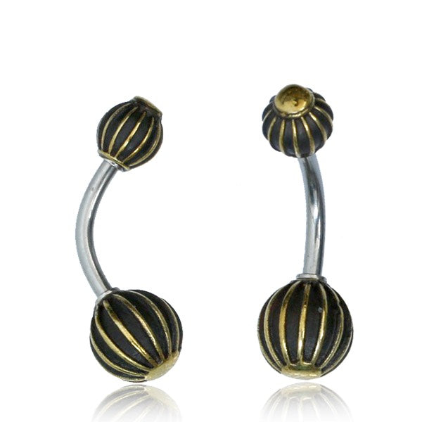 belly button naval piercing with decorative brass striped balls at each end