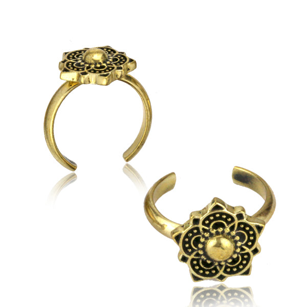 Two Brass toe rings decorated with a mandala on a white background