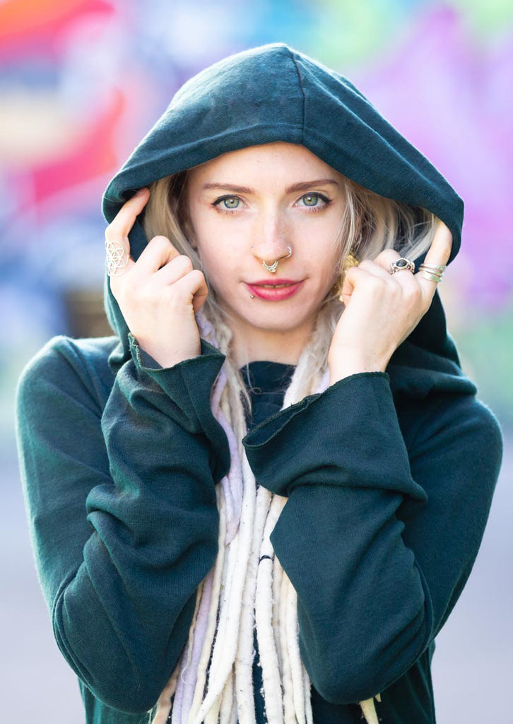 A blonde girl wearing a pullover in blue colour