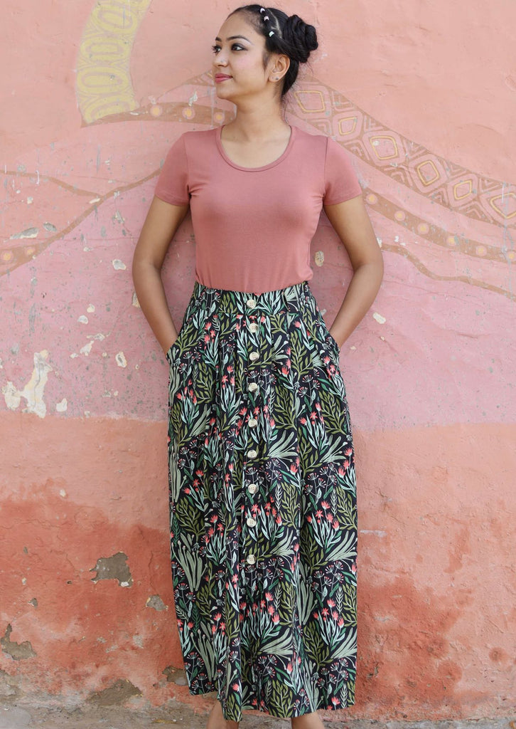 Model wearing a long skirt with floral motifs