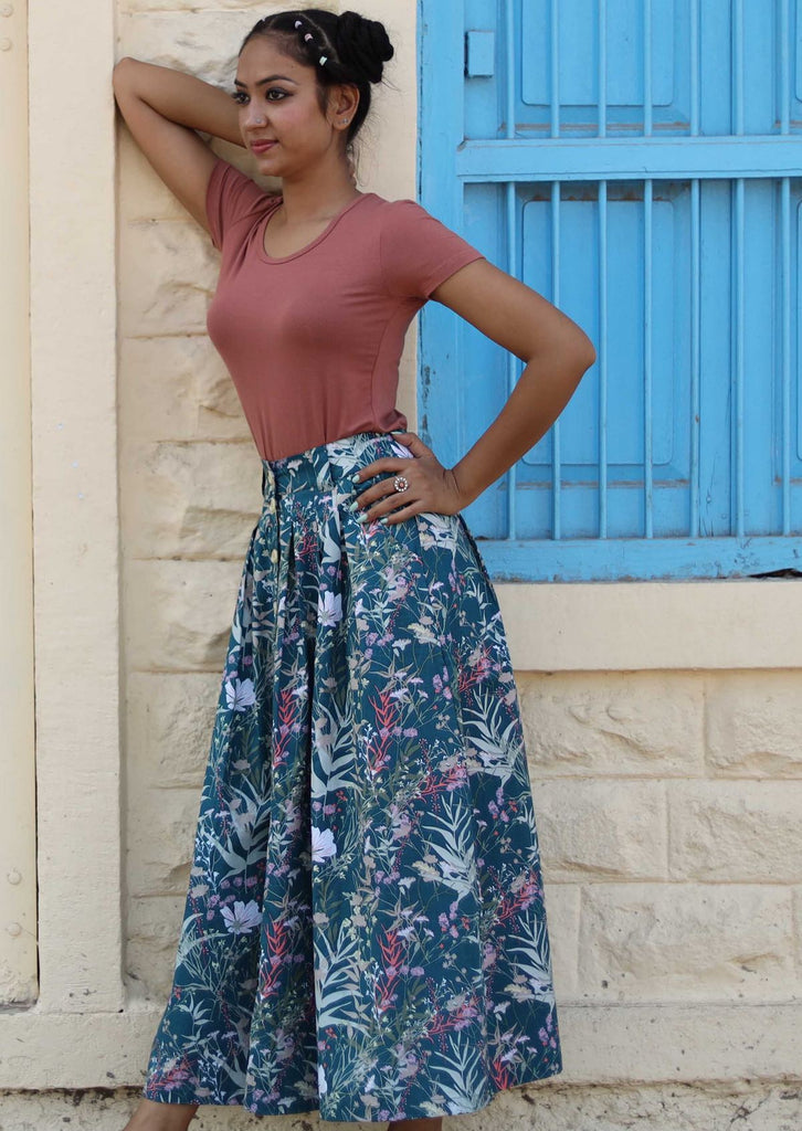 Model wearing a long skirt with floral motifs