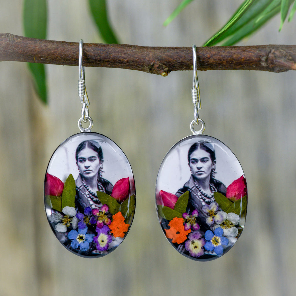 san marco silver and resin pendant earrings featuring a black and white photograph of frida kahlo adorned with colourful dried flowers