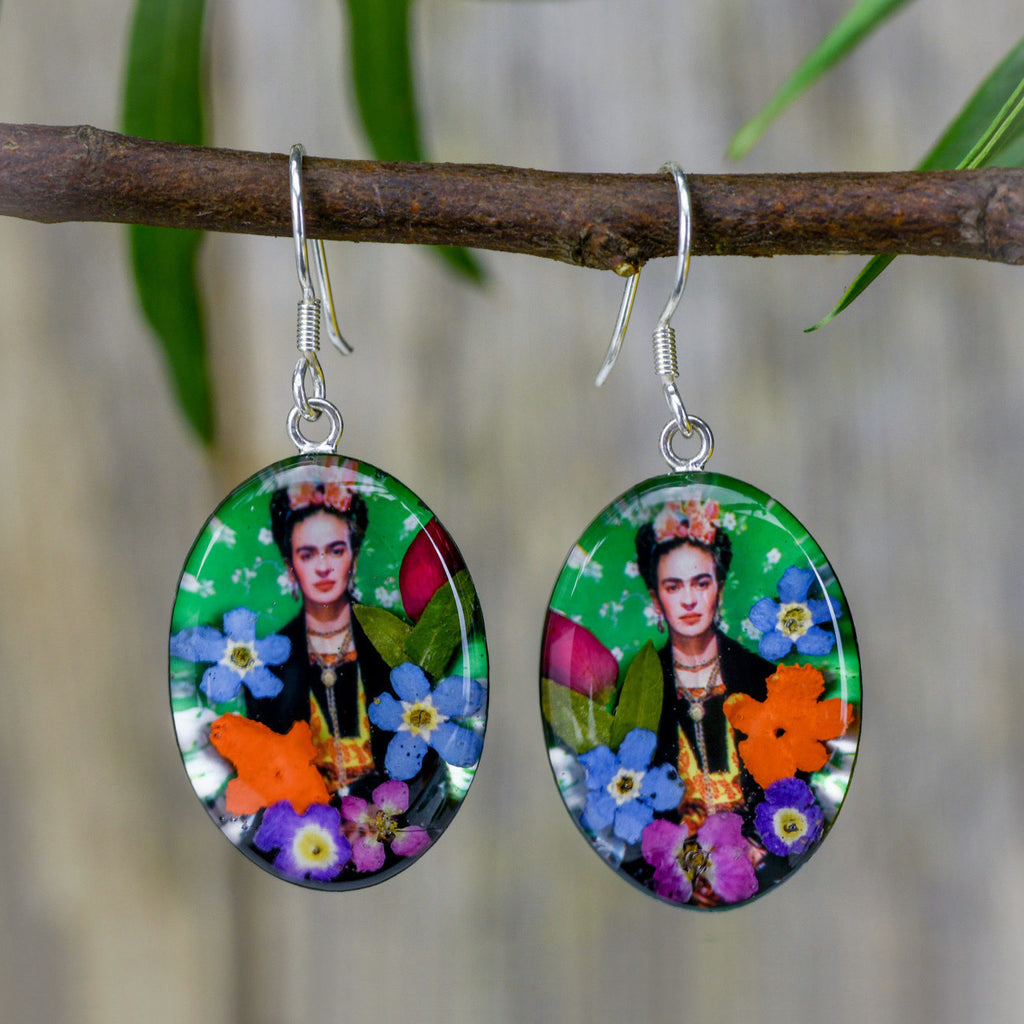 san marco silver and resin pendant earrings featuring a photograph of frida kahlo wearing a floral headress adorned with colourful dried flowers