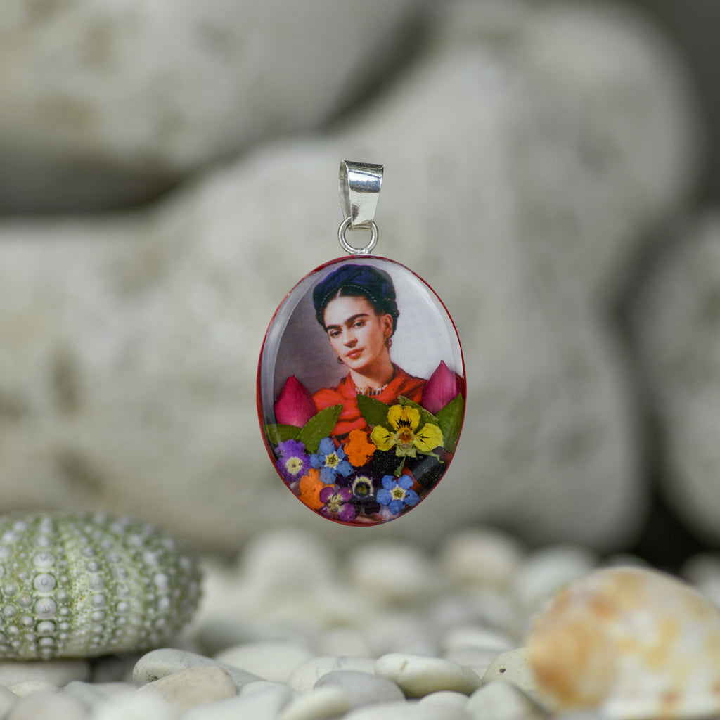 san marco silver and resin pendant with photograph of frida kahlo wearing a scarlet scarf adorned with colourful dried flowers and set in resin
