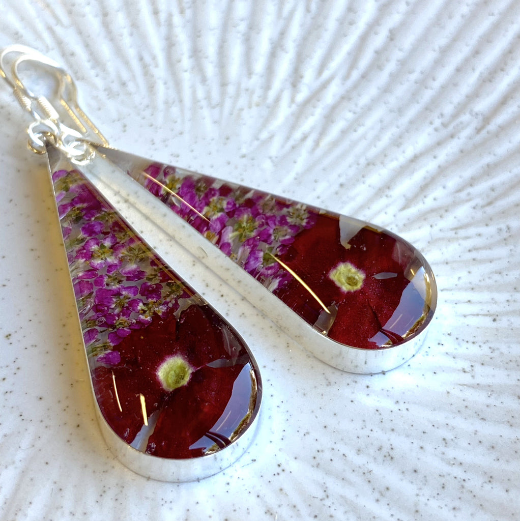 san marco long teardrop shaped silver and resin earrings with dried crimson and deep pink flowers encased in the resin