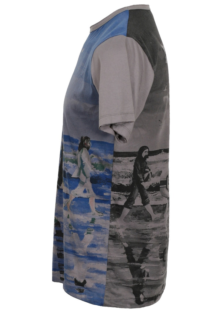 Grey T-shirt featuring a painterly design of the beatles walking along a beach with beach toys from the side