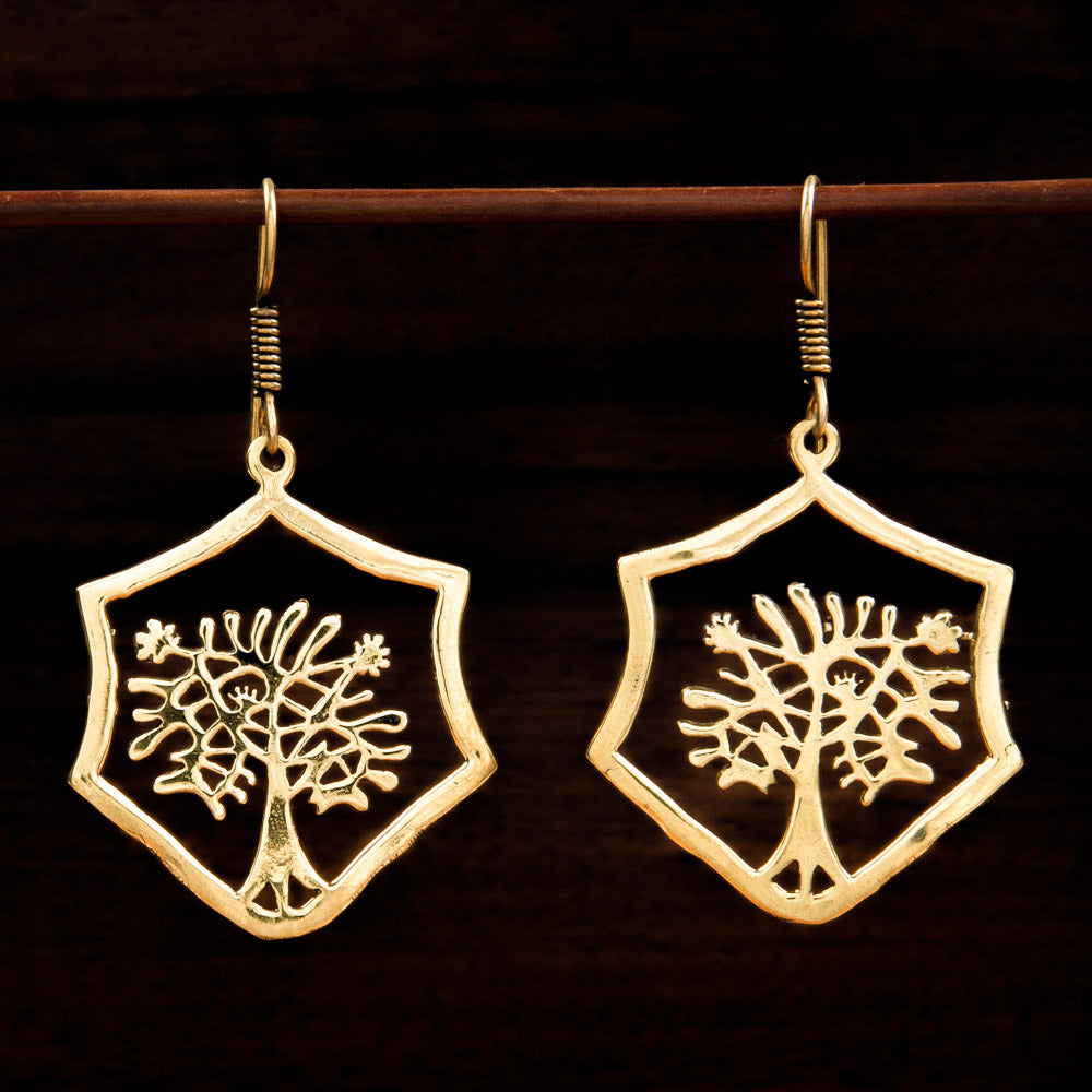 brass earrings with tree silhouette in rough hexagonal frame