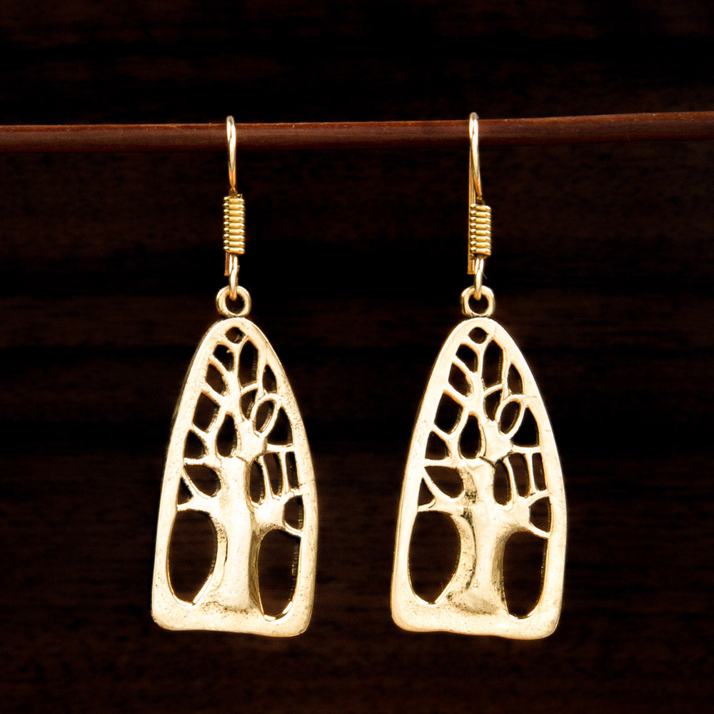 brass earrings with naive silhouetted tree of life graphic 