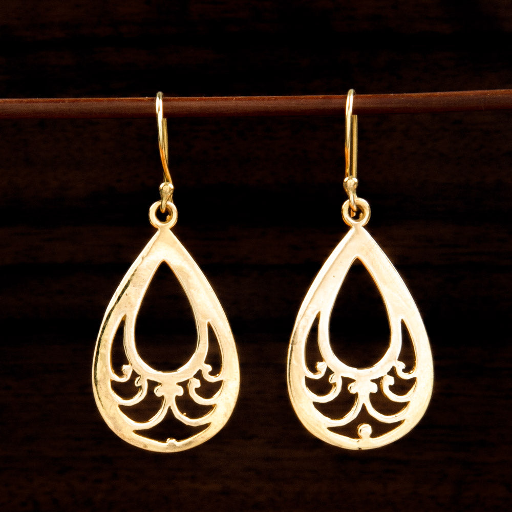 Teardrop shaped brass earrings with teardrop cut-out and paisley-like detail