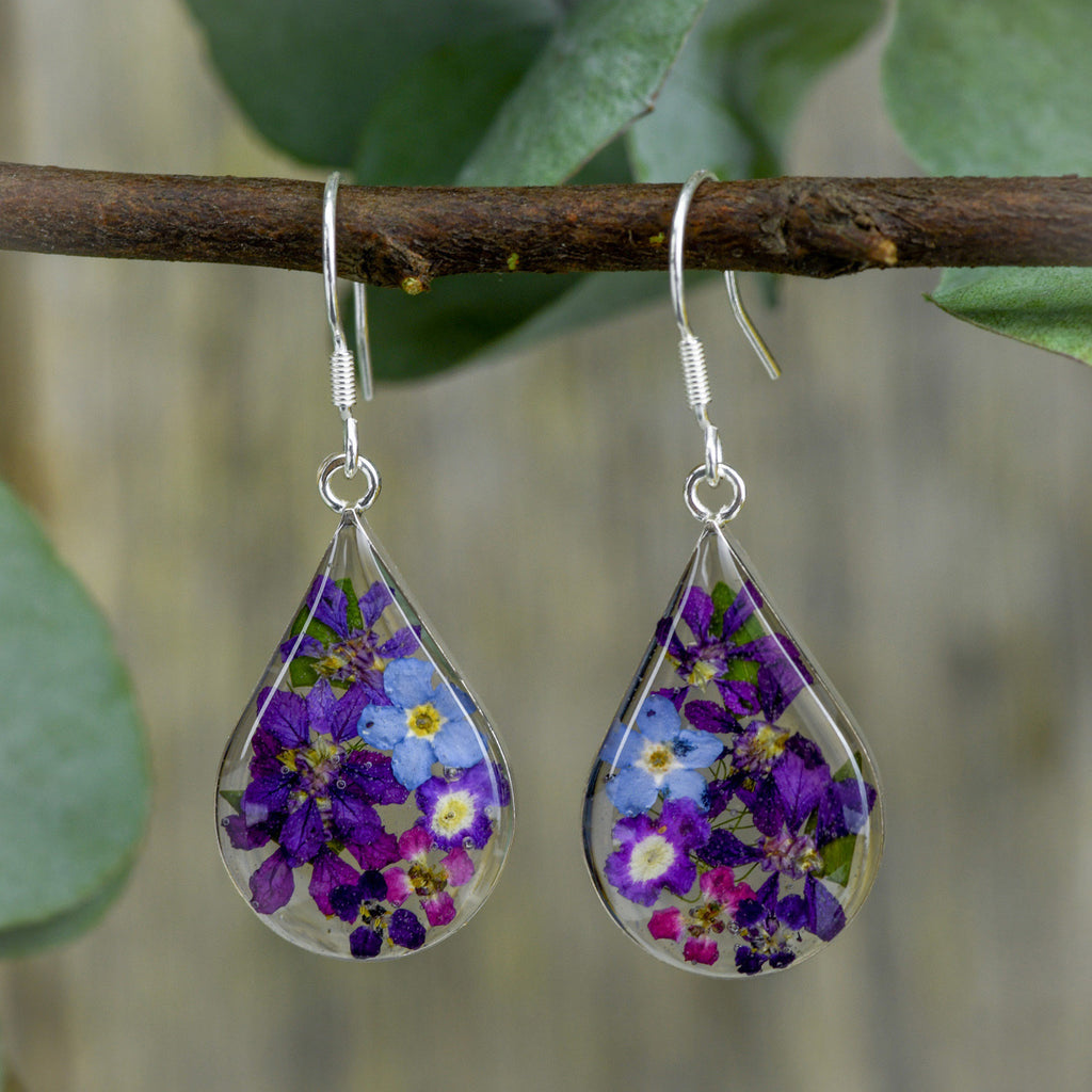 san marco medium sized droplet shaped silver and resin earrings with purple and complementary coloured dried flowers encased in the resin