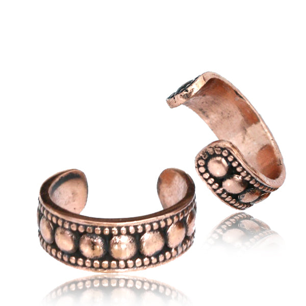 Two copper Ear cuffs featuring a dotted design on a white background