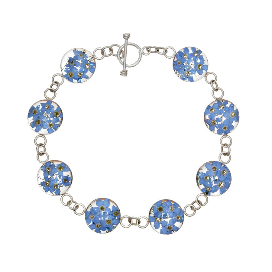 san marco silver and resin bracelet with dried blue flowers encased in the resin of eight small round sections and joined by silver links