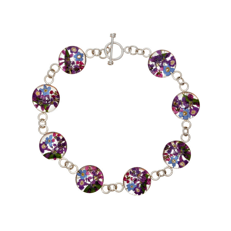 san marco silver and resin bracelet with purple and complementary toned dried flowers encased in the resin of eight small round sections and joined by silver links