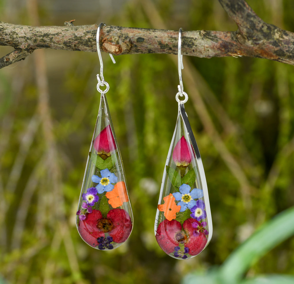 san marco long teardrop shaped silver and resin earrings with various coloured dried flowers encased in the resin