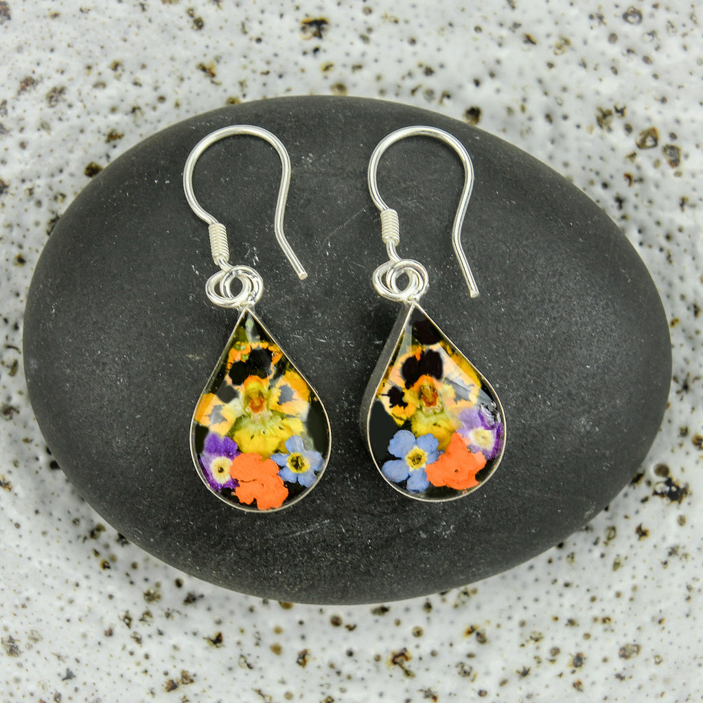 san marco small teardrop shaped silver and resin earrings with various coloured dried flowers encased in the resin
