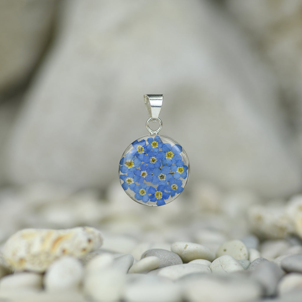 san marco medium sized round silver and resin pendant with dried blue flowers encased in the resin